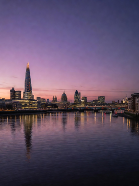 London skyline at twilight featuring the River Thames and urban night scenery