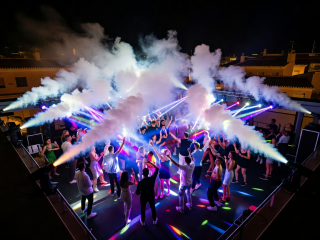 Terrace open-roof dance floor with CO2 cannons blasting over crowd in Spain